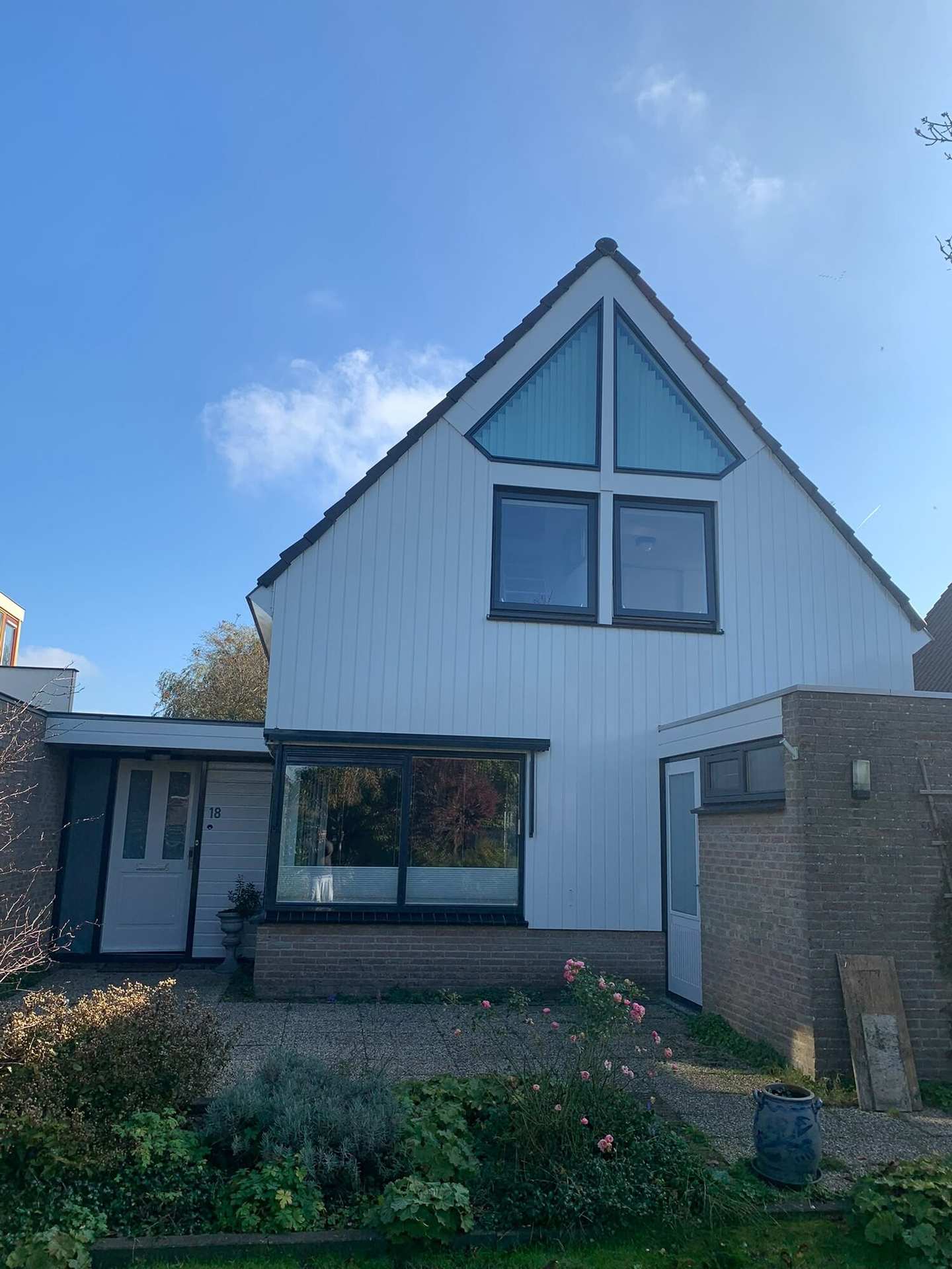 Vrijstaande woning in Oudorp met witte topgevel en donkere kozijnen